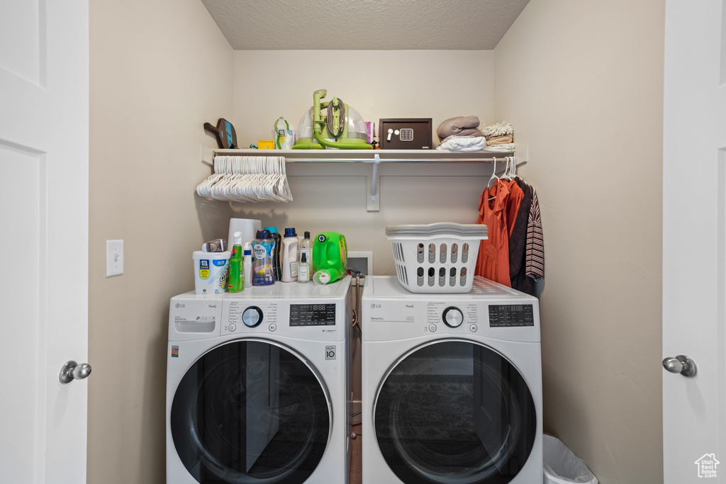 Laundry area with washing machine and clothes dryer