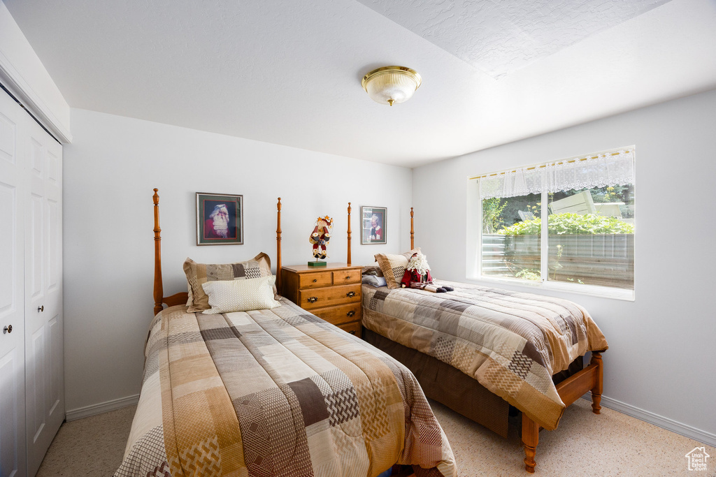 Bedroom featuring a closet and light carpet