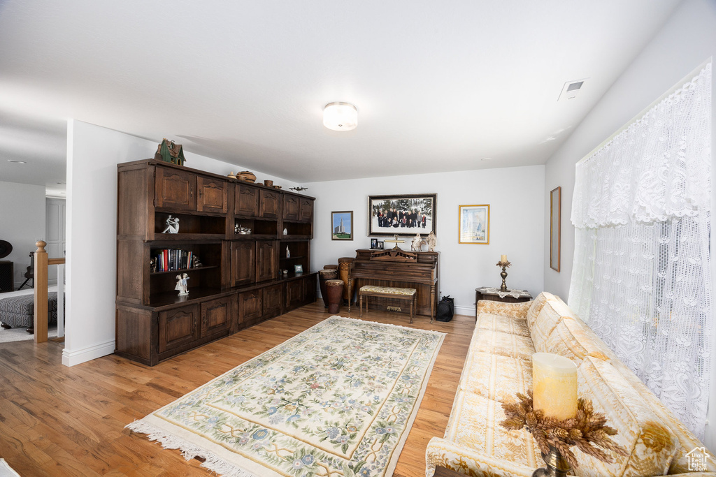 Living room with light wood-style flooring and baseboards
