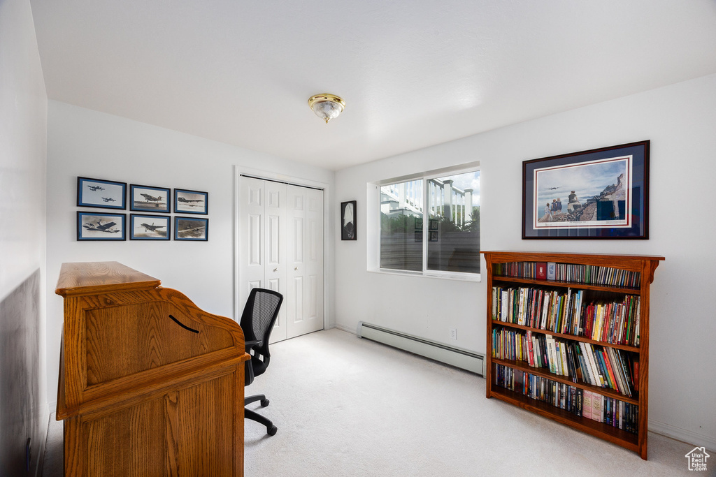 Home office with a baseboard radiator and carpet flooring