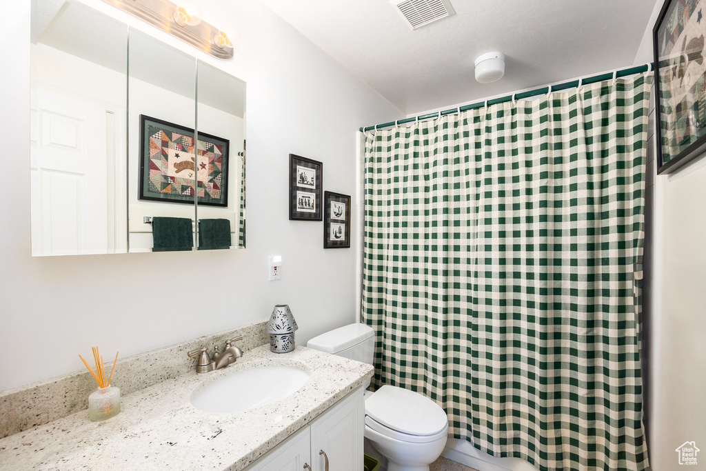 Bathroom with vanity and curtained shower