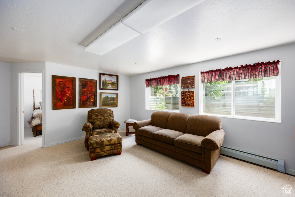 Carpeted living room with a baseboard radiator