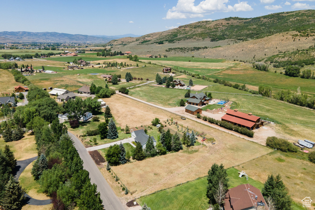 Aerial view of sparsely populated area featuring a mountainous background and agricultural land