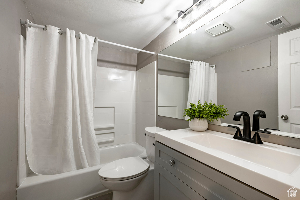 Full bathroom with shower / tub combo and vanity