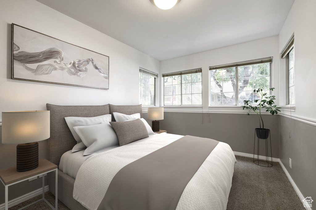 Carpeted bedroom featuring multiple windows