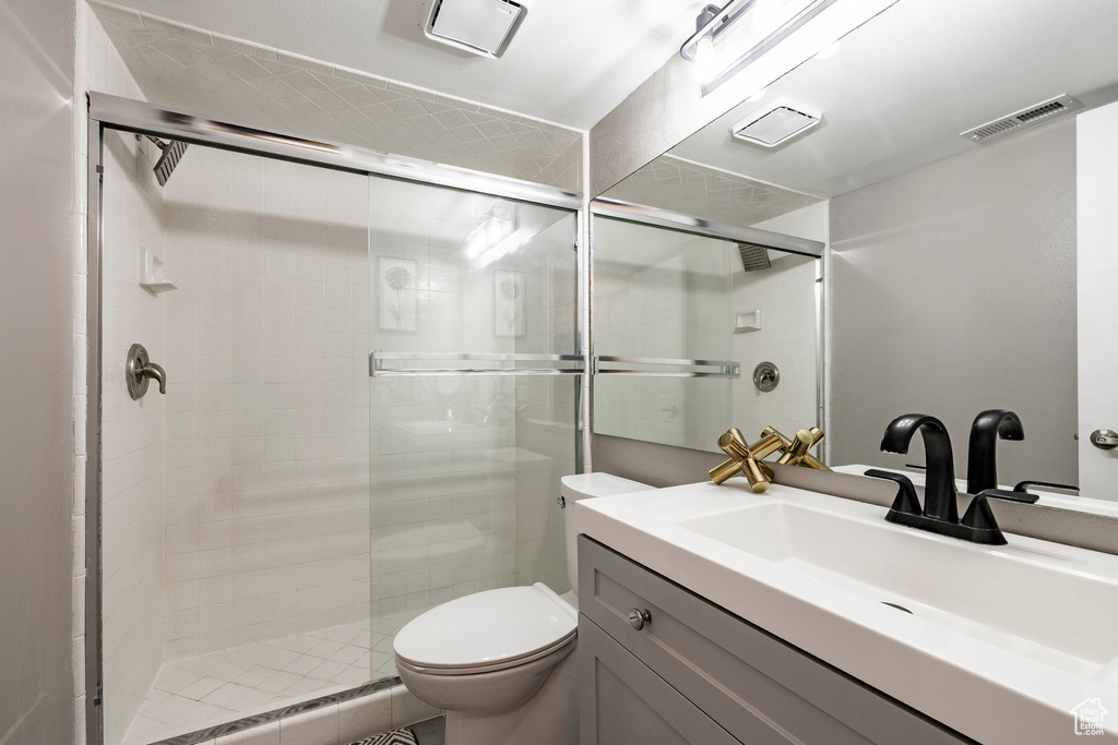 Full bathroom featuring a stall shower and vanity