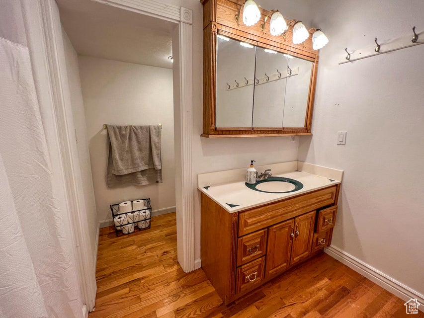 Full bathroom with wood finished floors and vanity
