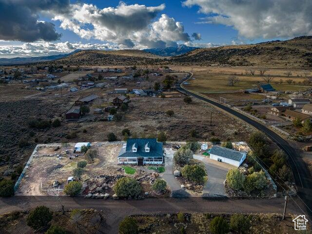 Aerial view of property's location with a mountain backdrop