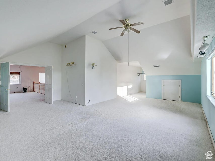 Bonus room featuring vaulted ceiling, carpet flooring, and ceiling fan