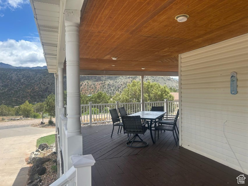 Wooden terrace with a mountain view and outdoor dining space