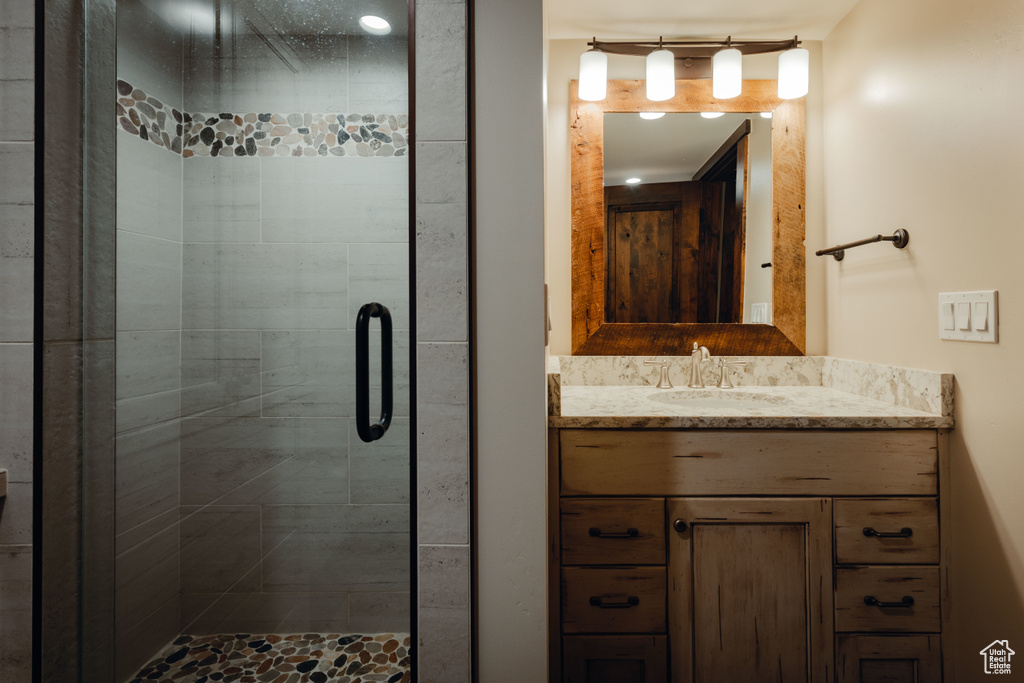 Bathroom with a shower stall and vanity