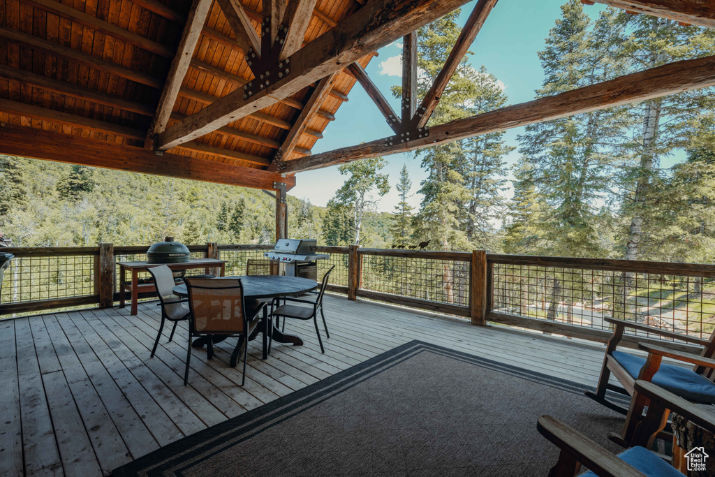 Wooden terrace with outdoor dining area and grilling area