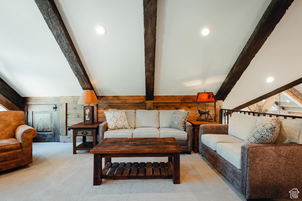 Living room featuring wood walls and light carpet