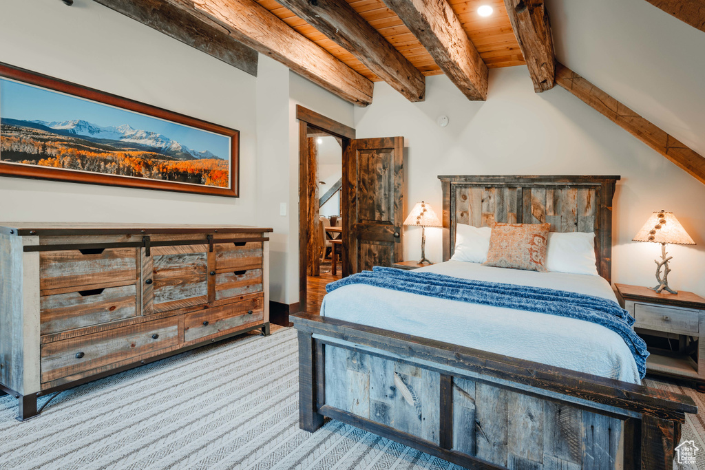 Carpeted bedroom with beam ceiling