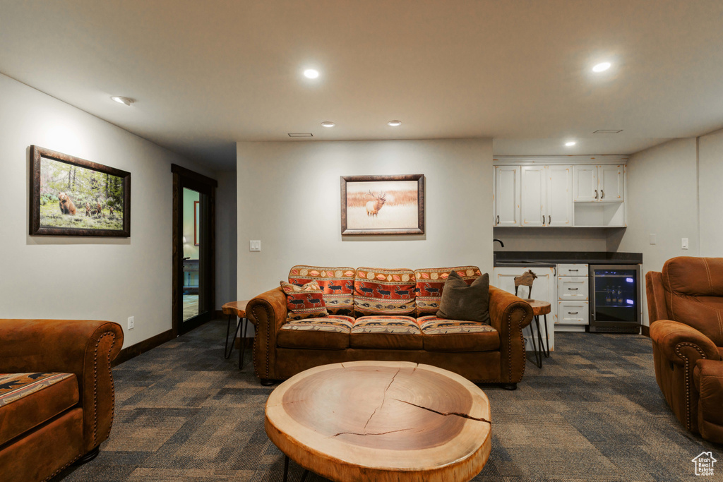 Living area with wine cooler, dark carpet, bar, and recessed lighting