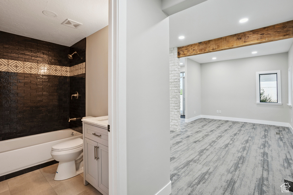 Full bath featuring vanity, shower / bath combination, wood finished floors, and recessed lighting