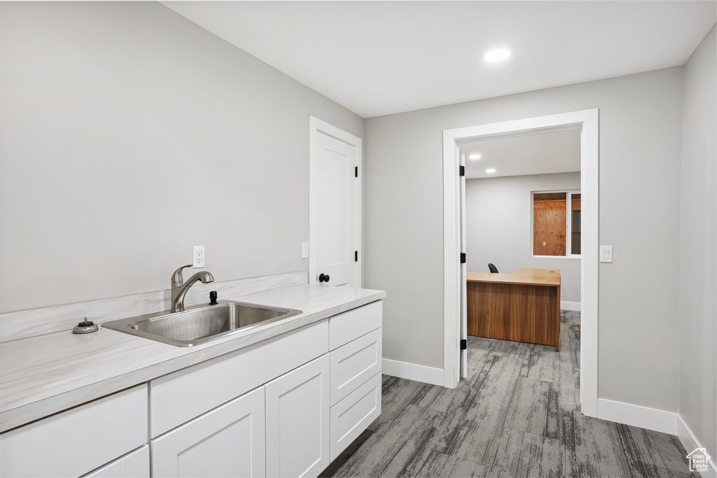 Laundry room with wood finished floors and recessed lighting