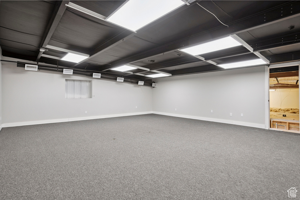 Finished basement featuring baseboards and carpet flooring