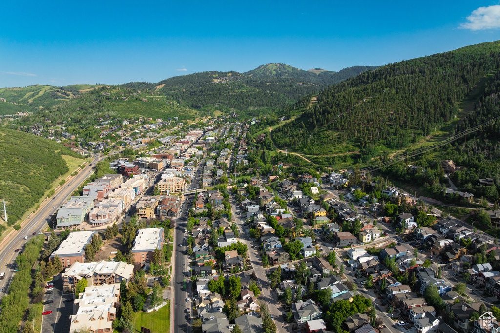 View of property location with a mountain backdrop and nearby suburban area