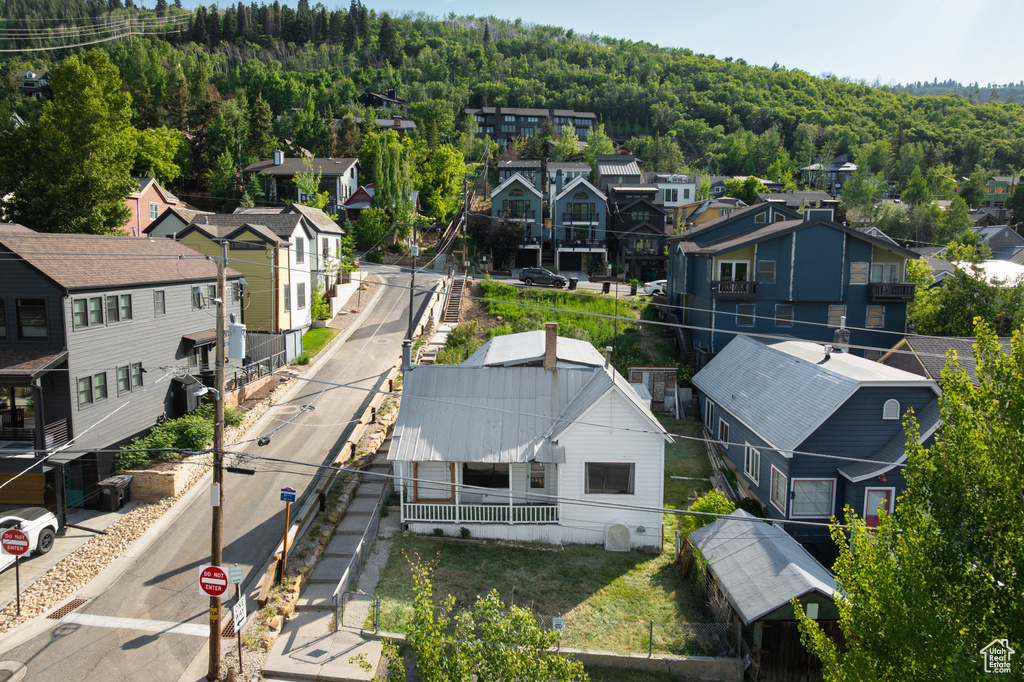 Aerial perspective of suburban area with a forest