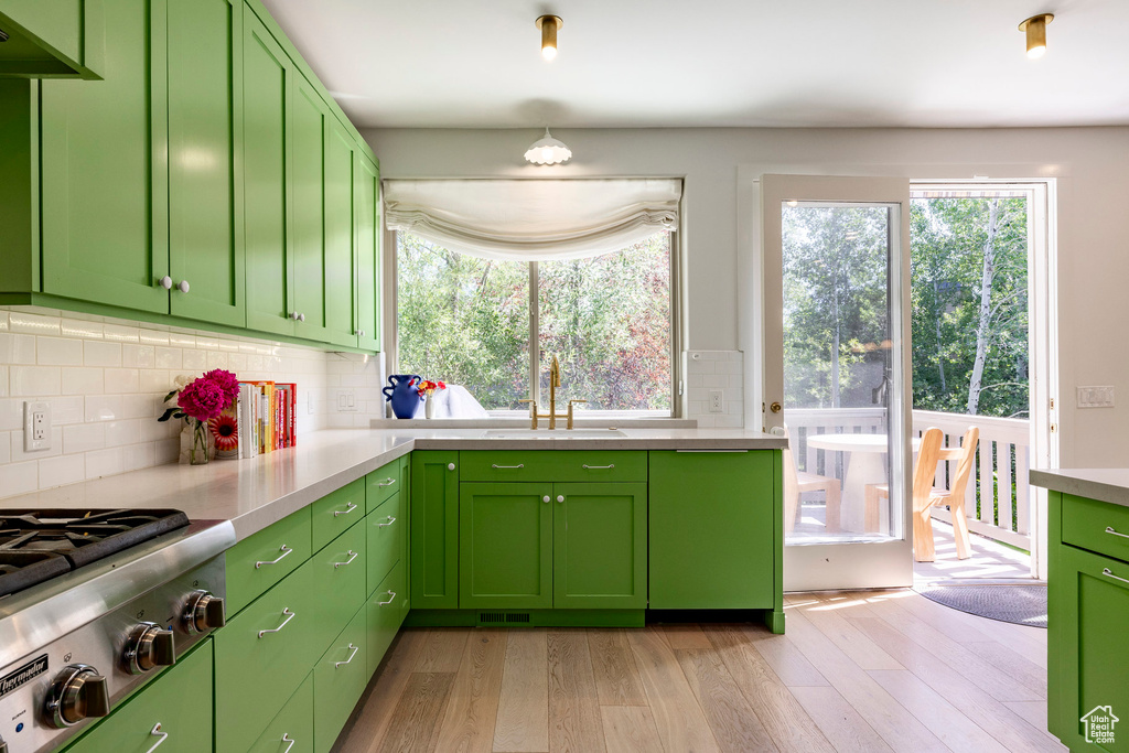 Kitchen featuring healthy amount of natural light, stainless steel gas cooktop, and light wood-style floors