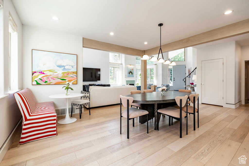 Dining space featuring stairs, light wood-style flooring, plenty of natural light, and recessed lighting