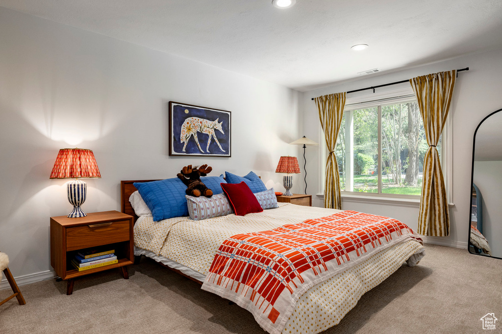 Carpeted bedroom with baseboards and recessed lighting