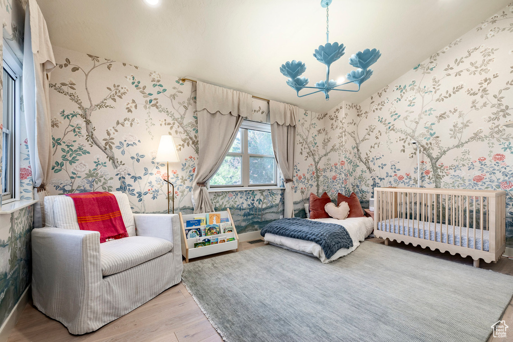 Bedroom featuring light wood finished floors, wallpapered walls, and recessed lighting