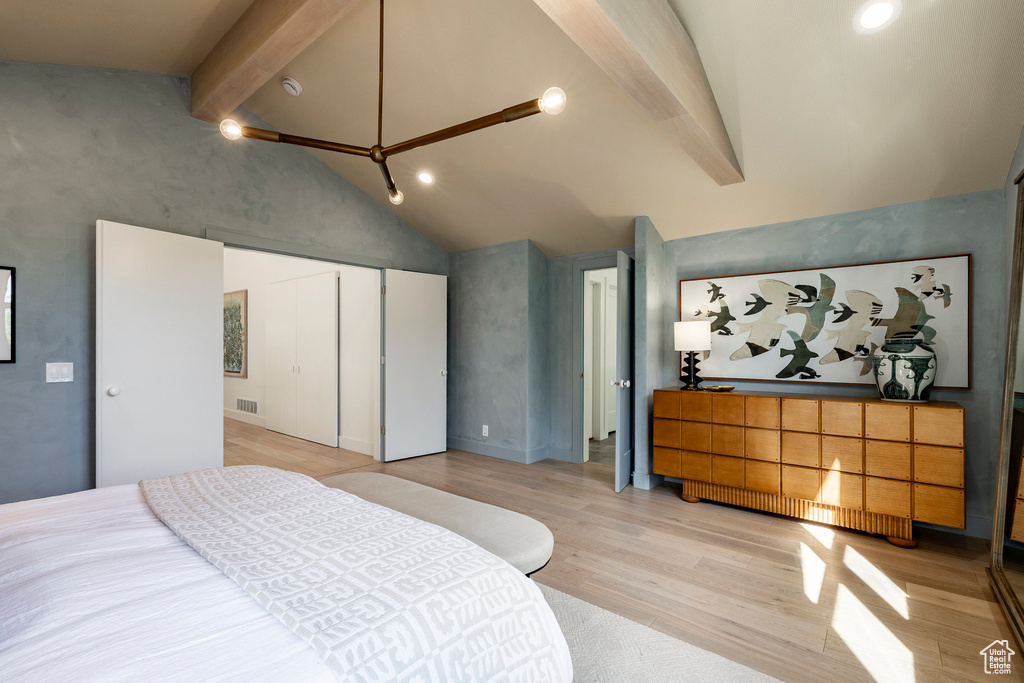Bedroom with beamed ceiling, light wood finished floors, a closet, recessed lighting, and high vaulted ceiling