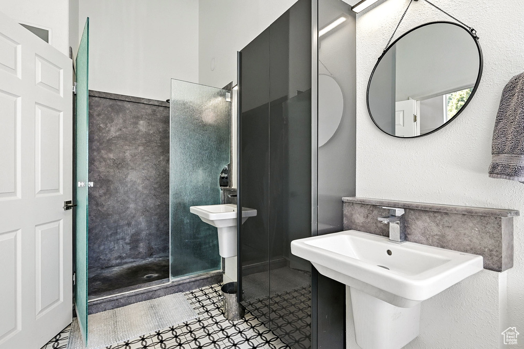 Bathroom with a walk in shower and a sink