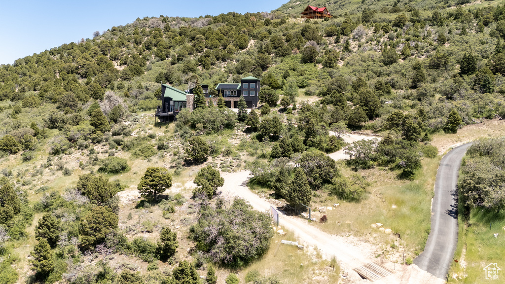 View from above of property featuring a heavily wooded area