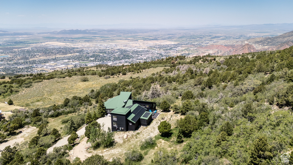 View of subject property with mountains and a forest