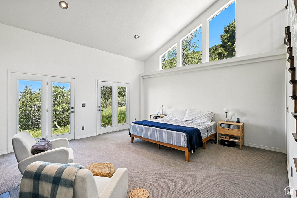 Carpeted bedroom with access to exterior, high vaulted ceiling, and recessed lighting