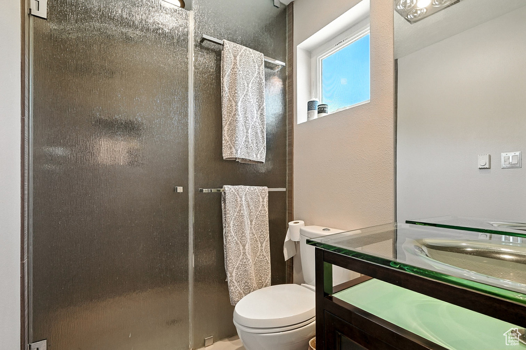 Full bath featuring vanity and a shower stall