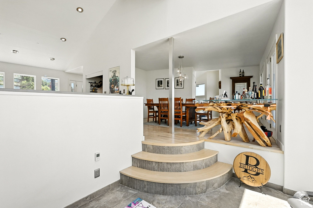Stairs with recessed lighting and lofted ceiling