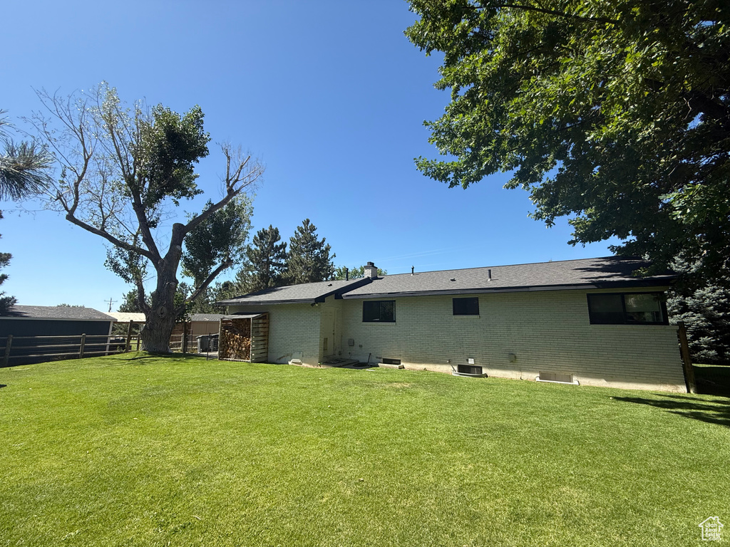 Rear view of property featuring brick siding and a chimney