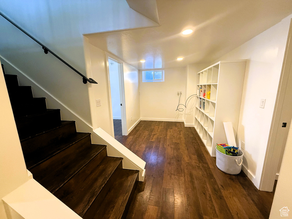 Stairs featuring hardwood / wood-style floors and baseboards