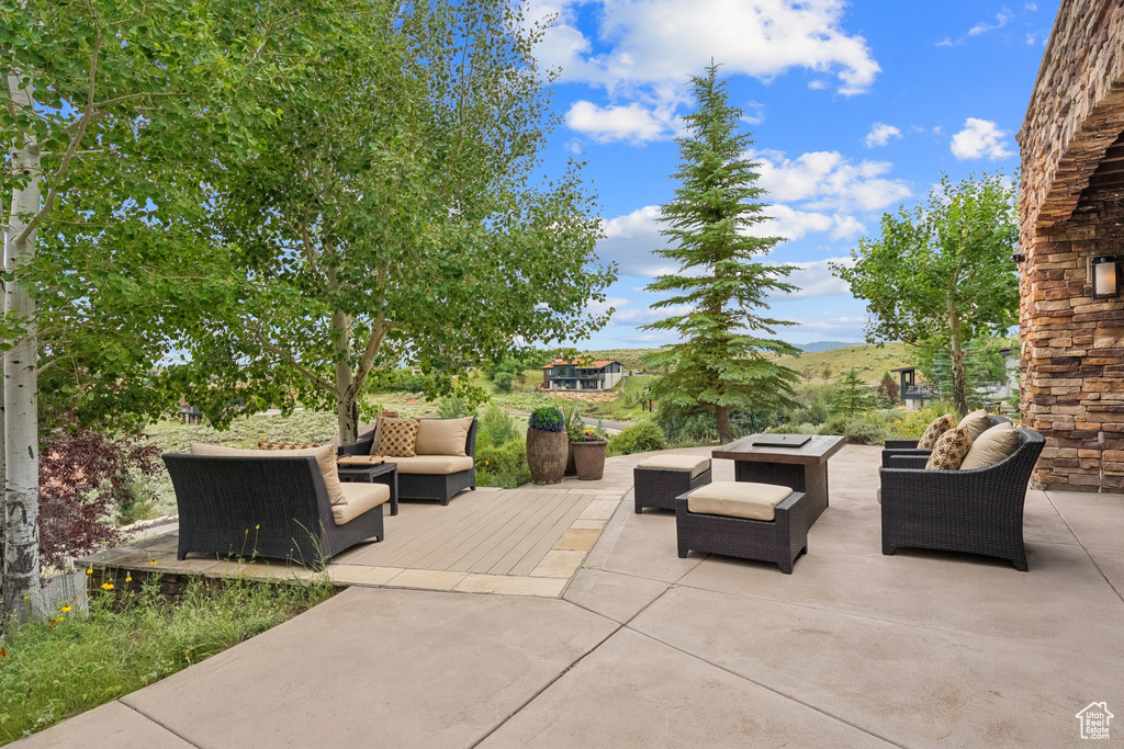 View of patio with outdoor lounge area and a deck