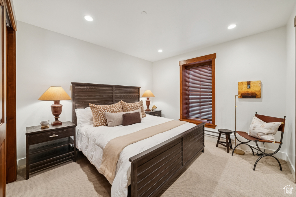 Bedroom with light colored carpet and recessed lighting
