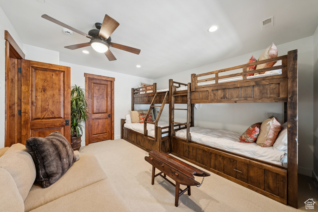 Carpeted bedroom with recessed lighting and ceiling fan