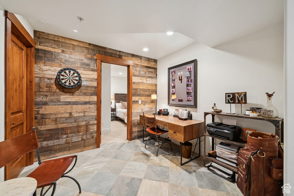 Home office featuring wood walls, recessed lighting, and an accent wall