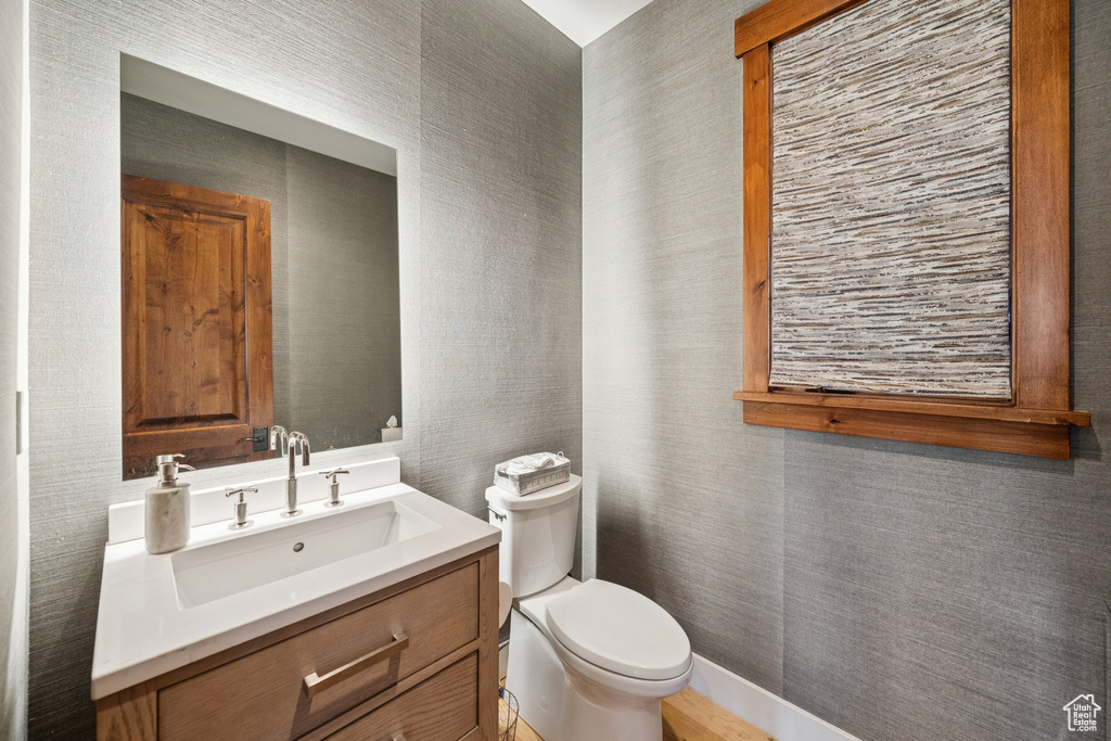 Half bath featuring toilet and vanity