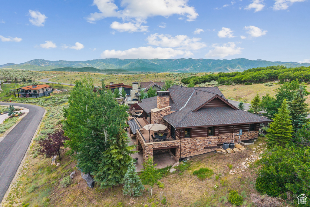 View of subject property featuring a mountainous background