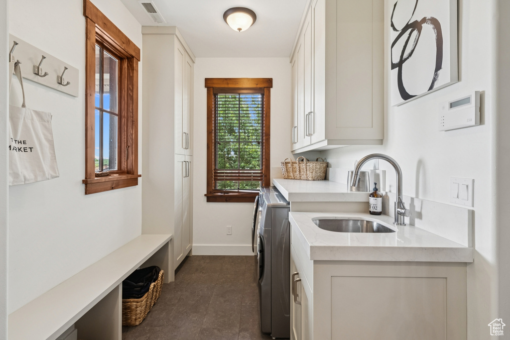 Laundry area featuring cabinet space and separate washer and dryer