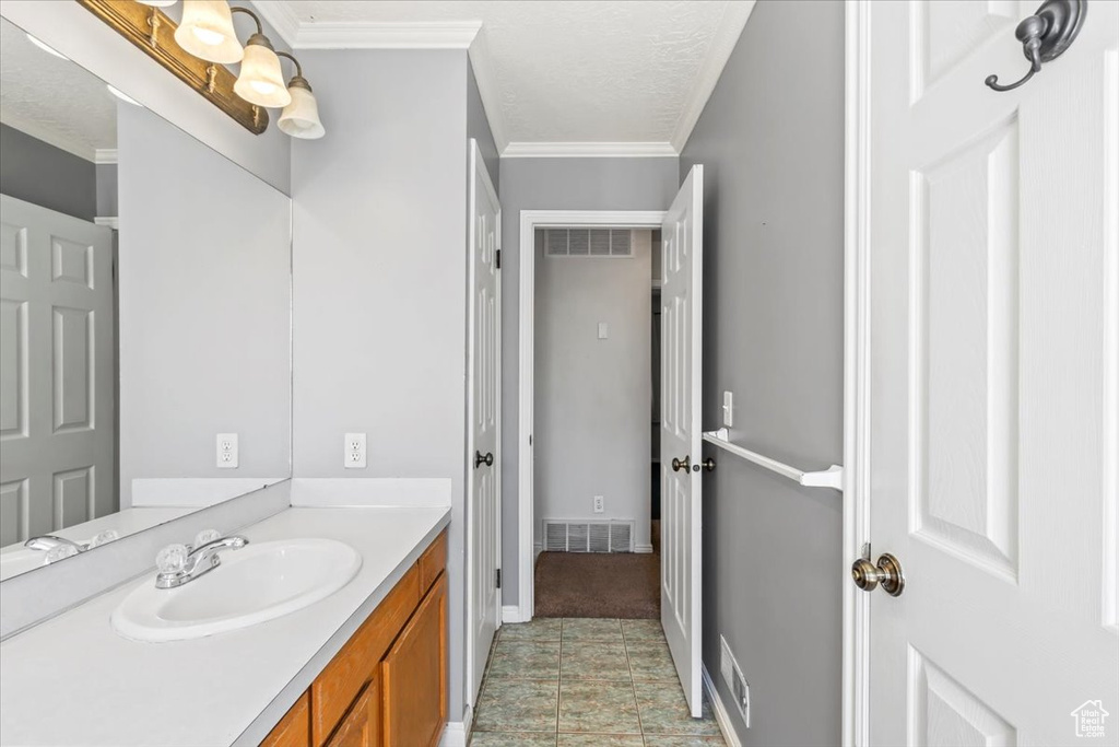 Bathroom featuring vanity and ornamental molding