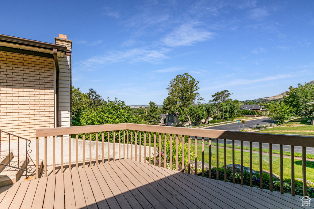 Wooden terrace featuring a lawn