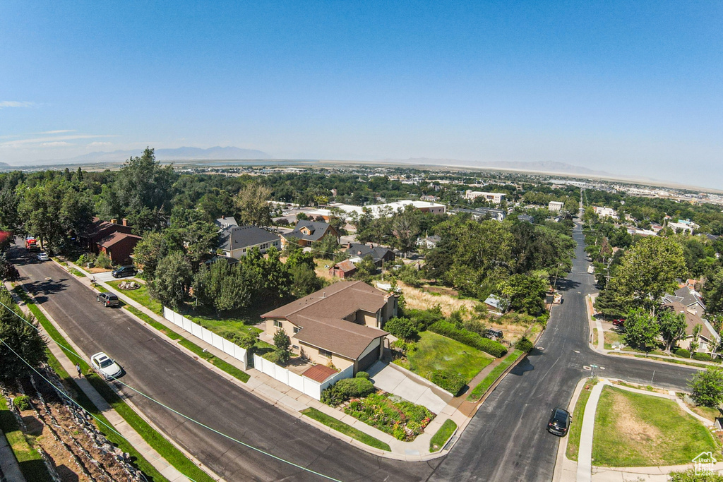 Aerial view of property and surrounding area with nearby suburban area
