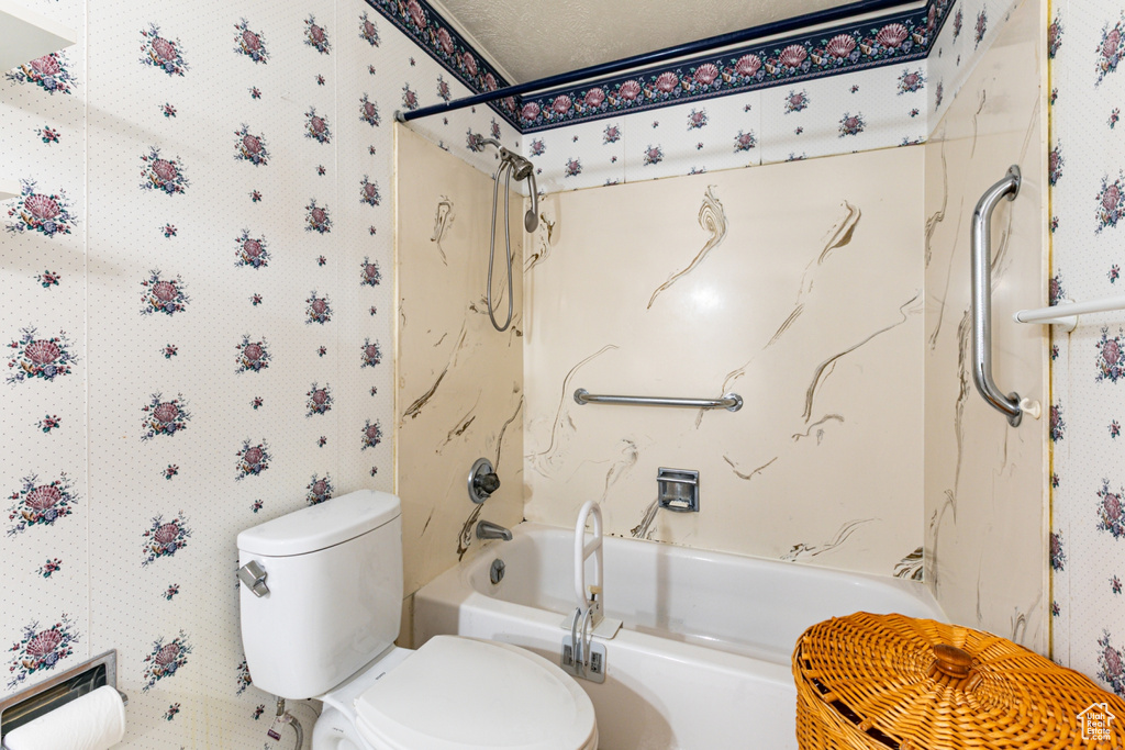 Bathroom featuring  shower combination and wallpapered walls