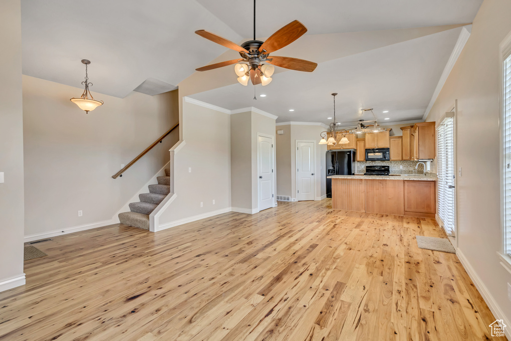 Unfurnished living room with light wood-style flooring, recessed lighting, a ceiling fan, ornamental molding, and stairway