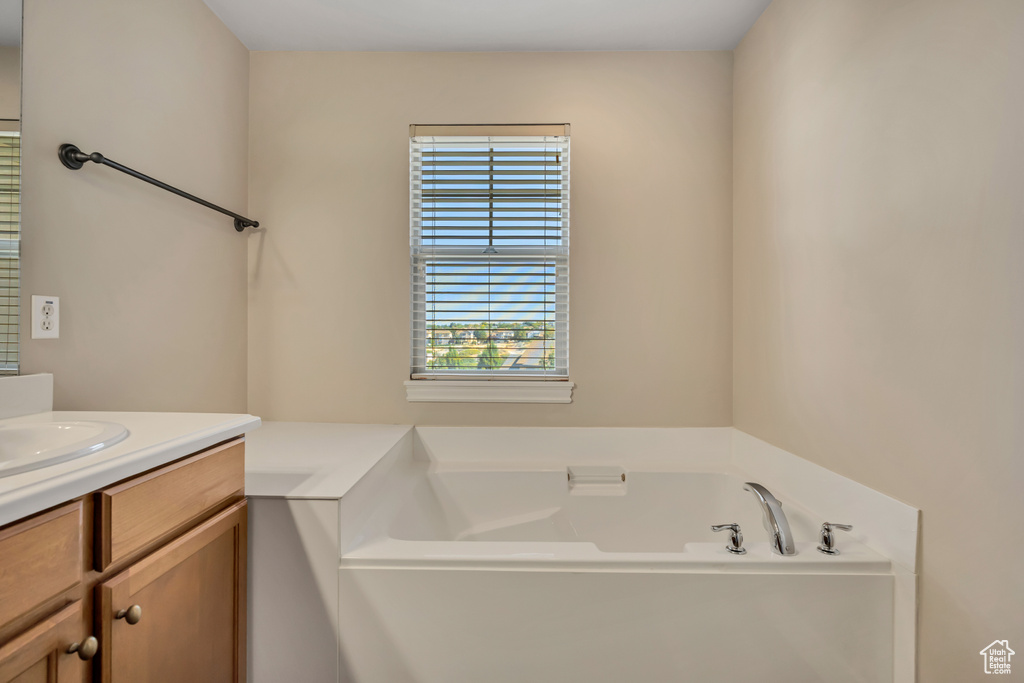 Full bathroom with vanity and a bath